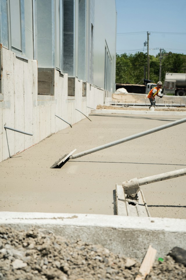 A professional set of ratchet wrenches and sockets organized alongside high-density concrete repair equipment